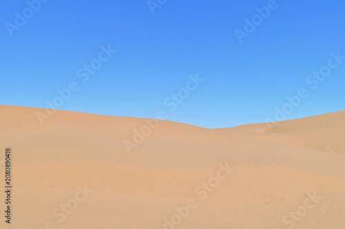 Panoramic View of the Golden Sand Dunes of Xiangshawan Desert in Inner Mongolia, China. Vast Desert Landscape with Rippled Sand Under a Clear Blue Sky, Showcasing the Natural Beauty of the Gobi Region
