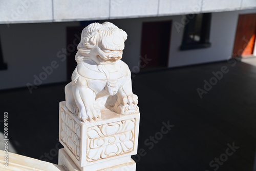 Traditional Marble Lion Sculpture Guarding Buddhist Temple at Yihe Ecological And Cultural Expo Park in Ordos, Inner Mongolia, China