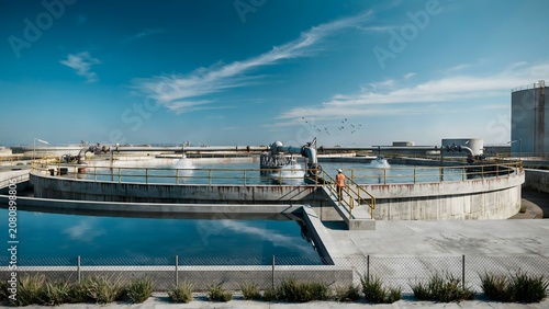 Aerial View of a Large Water Treatment Facility with Circular Tanks and Infrastructure