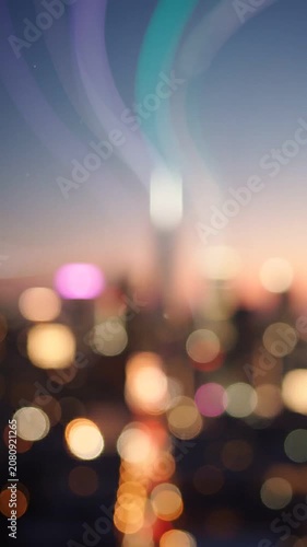 Captivating Urban Sunset: A Dreamy View of Blurred City Lights and Skyscrapers at Dusk with a Soft Color Palette Exhibiting a Serene Atmosphere of Evening Life