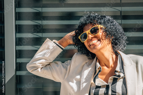 portrait of smiling woman with sunglasses