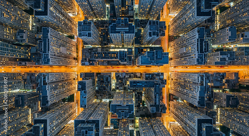 Night aerial view of dense urban skyscraper apartment buildings in city grid light