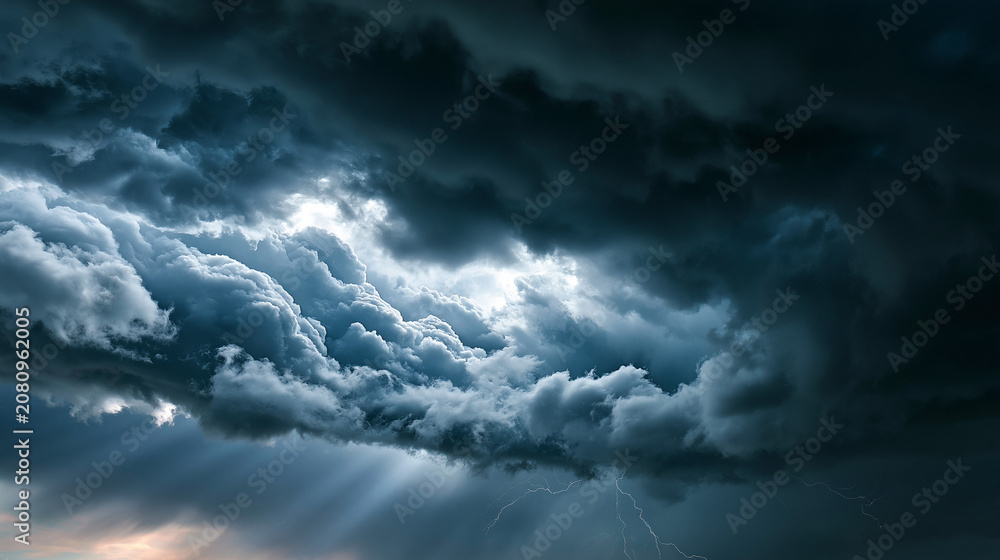 Obraz premium Dramatic storm clouds churning across the sky in heavy layered structure brooding atmospheric background severe weather with copy space