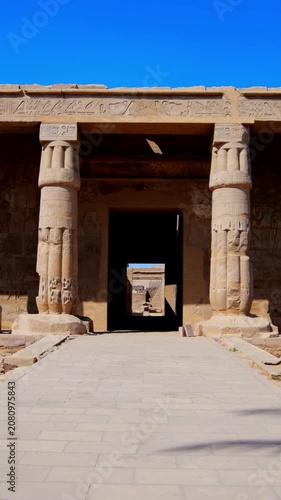Seti I mortuary temple entrance with palm tree alley and ancient stone ruins in