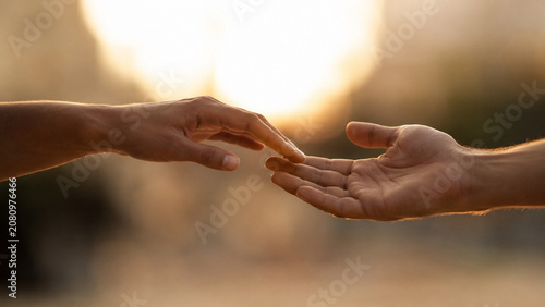 Two Hands Reaching Toward Each Other in a Gesture of Love and Connection
