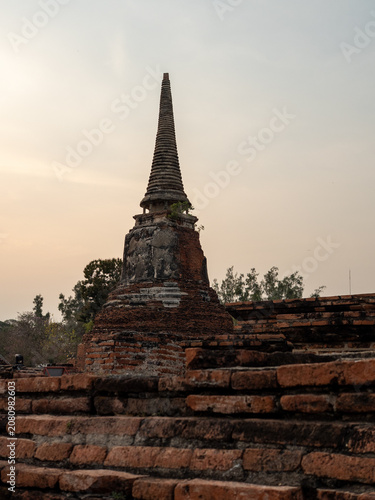 Ancient Brick Pagoda Ruin in Ayutthaya, Thailand at Sunset