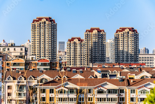 Modern Apartment Towers Above Residential Rooftops