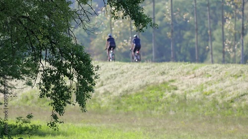 Cyclists riding along the Danube embankment at sunset