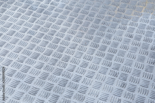 Aluminum Checker Plate Texture. Close-Up of a Non-Slip Metal Tread Surface. Patterned Aluminum Tread Plate Background. Industrial Metal Surface with Anti-Slip Texture