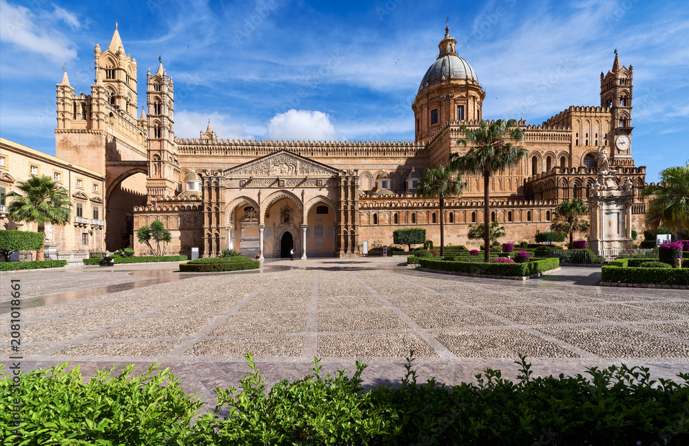 Fototapeta premium PALERMO, ITALY - JUNE, 2026: Exterior view of the historic Palermo Cathedral with its Arab-Norman architecture under a blue sky on a sunny day