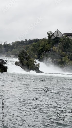 SCHAFFHAUSEN, SWITZERLAND - OCTOBER 11, 2025: View of the Rhine Falls with the powerful Rhine River flowing through the famous natural landmark.