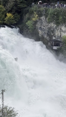 SCHAFFHAUSEN, SWITZERLAND - OCTOBER 11, 2025: View of the Rhine Falls with the powerful Rhine River flowing through the famous natural landmark.