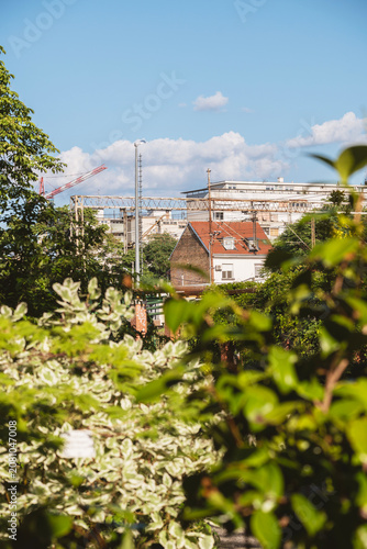 Old houses and apartment blocks next to the train railway passing next to the Zagreb city botanical garden