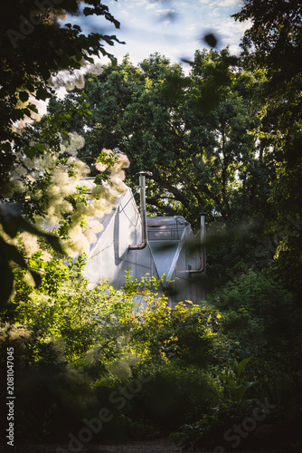 Greenhouses in the Zagreb city botanical garden, hidden by the trees and vegetation