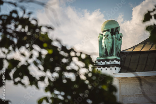 Beautiful owl statues made from cooper, standing on the rooftop of croatian state Archives building in the Zagreb city, Croatia