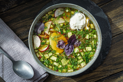 Bowl of russian okroshka cold soup with vegetables and egg
