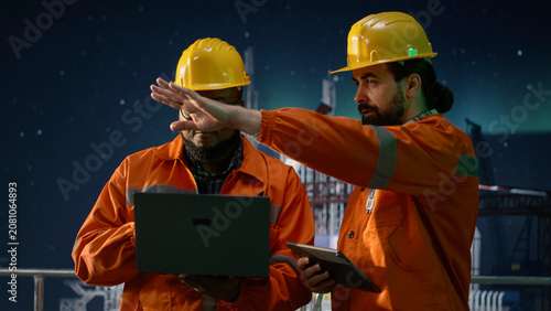 Obraz na płótnie Reviewing maritime security incidents, geopolitical conflict and offshore rig installation manager using tablet, overseeing embargo affecting operations
