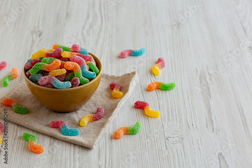 Sugary Sour Gummy Worms in a Bowl, side view. Copy space.