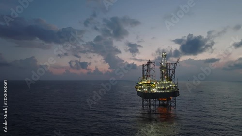 Aerial view of offshore jack up rig and offshore platform during sunset for oil and gas exploration and production. 