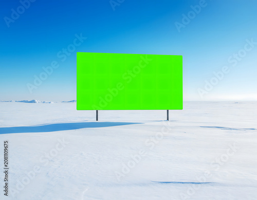 Blank Green Screen Billboard Standing in a Vast Snowy Arctic Landscape under a Clear Blue Sky