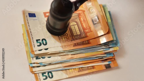 Judges gavel and euro banknotes.Imposition of a monetary penalty. Judges gavel and euro banknotes. Court costs, compensation, and expenses