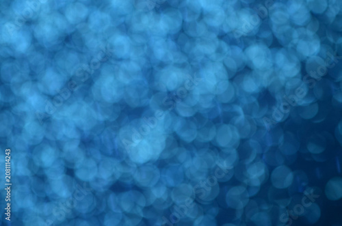 Light blue glitter bokeh background for winter holiday celebration and technology concepts