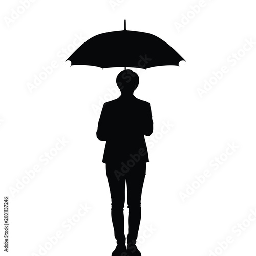 Silhouette of a person standing under a large open umbrella