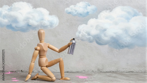 Wooden figure spray-paints clouds, pink splatters on concrete floor.