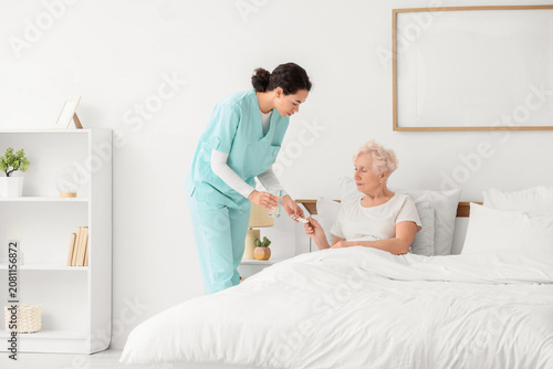 Senior woman taking pills f...