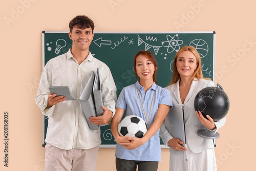 Teachers near blackboard in classroom