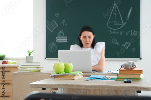 Apples with books on desk i...