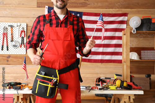 Male worker with USA flag a...