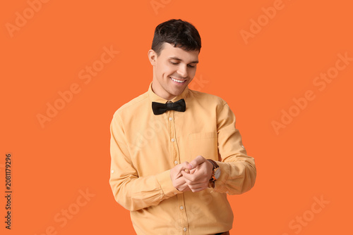 Happy young man with bow ti...