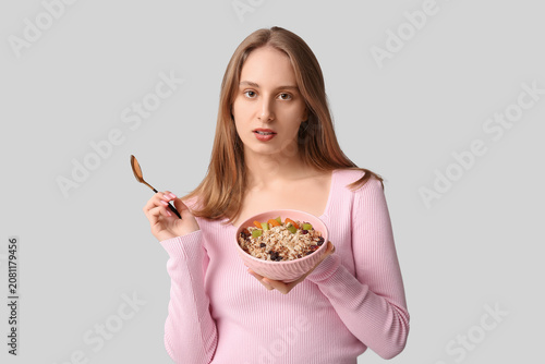 Young woman with bowl of he...