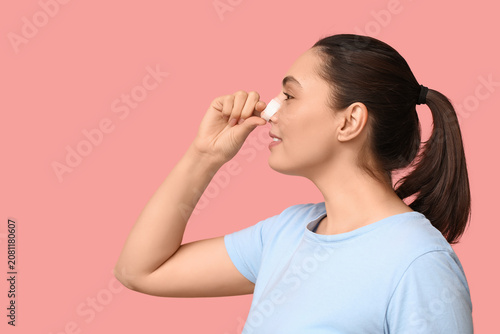 Young woman with bandaged n...