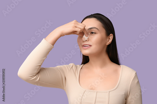 Young woman with bandaged n...