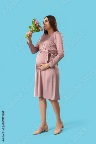 Young pregnant woman smelli...