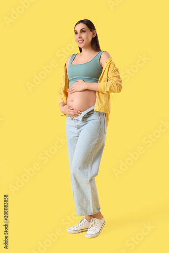 Young pregnant woman touchi...