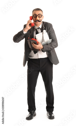 Businessman in funny disguise holding many different phones on white background