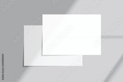 Blank white A4 paper sheets mockup on background with elegant organic shadow overlay. Perfect for displaying stationery designs, flyers, posters, branding, Ads and print design presentations