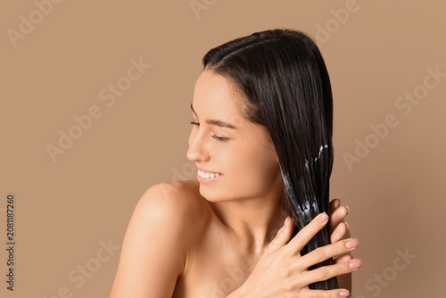 Young woman using cosmetics...