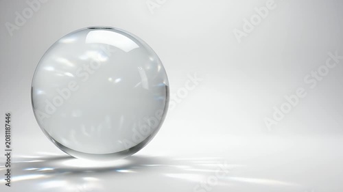 A perfectly clear glass sphere floating over a reflective surface with beautiful light refractions and a clean minimalist white studio background