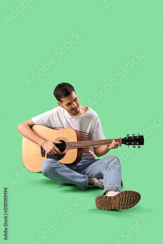 Handsome young man playing ...