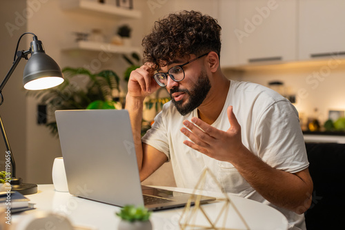 Cuadro en lienzo Arabian man at home ends remote laptop job feels bored tired stress burnout wants rest