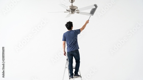Photorealistic person viewed from behind, no face, dusting ceiling fan, reaching up, isolated pure white backdrop