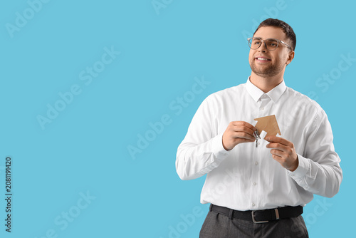 Male realtor with keys and ...