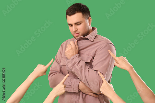 Photos People pointing at young man on green background