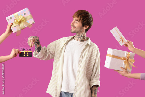 Young tattooed man with gif...