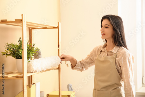 Young woman cleaning furnit...