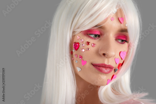 Young woman in white wig wi...